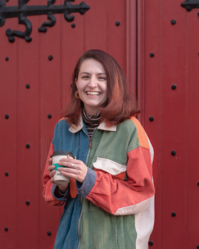 Headshot of MFA fiction student Samantha Kathryn O'Brien in a brightly colored zip-up jacket