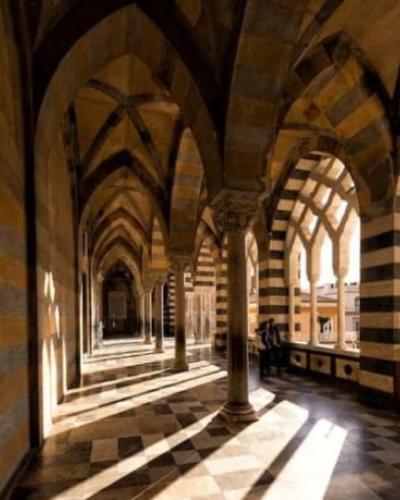 Photo of high stone archways on college campus